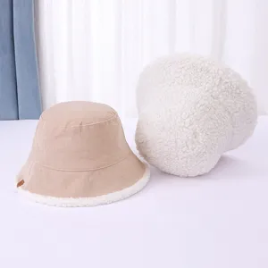 Detailed shot of reversible winter bucket hat, cozy corduroy and soft sherpa fleece.