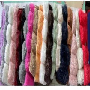 Detailed view of colorful faux fur fabric swatches, soft plush material options for winter hats.