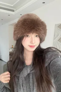 Close-up of the fluffy brown faux fur bucket hat showing soft plush texture and cozy winter styling.