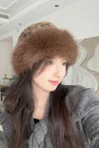 Trendy autumn winter plush bucket hat for women, stylish brown faux fur furry cap detail.