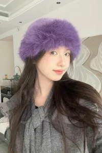 Detail view of the stylish purple fluffy bucket hat, soft faux fur texture for winter warmth.