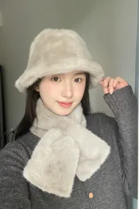 Close-up detail of the soft faux fur bucket hat and matching winter warm scarf.