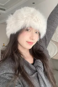Stylish white furry winter bucket hat for women, fluffy warm plush cap for cold weather daily wear.