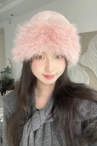 Stylish pink faux fur bucket hat, fluffy winter warm plush cap for women fashion detail.