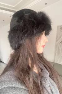 Detailed side view of a stylish black fluffy bucket hat, perfect winter accessory for women.
