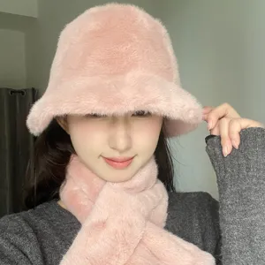 Pink plush bucket hat and warm scarf set worn by model for winter cold protection.