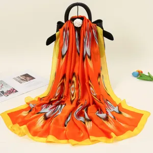 Women luxury silk feel satin long scarf with vibrant ethnic print, perfect for all seasons.