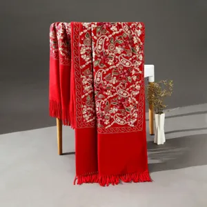 Detailed view of red cashmere-feel ethnic embroidered paisley shawl scarf with tassels.