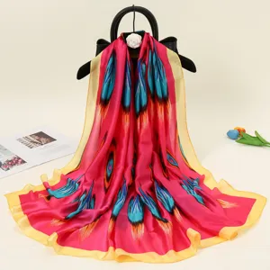 Vibrant pink silk scarf with traditional ethnic feather print, elegant long fashion shawl.