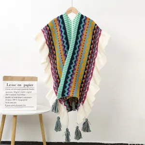 Ethnic style knitted poncho with colorful geometric stripes, ruffles and tassels.