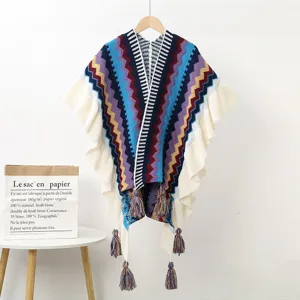 Bohemian multi-color zig-zag knit poncho with ruffles and tassels for women's winter travel.