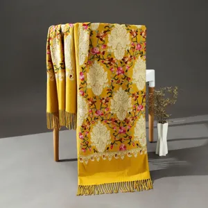 Detailed view of an ethnic embroidered cashmere-feel scarf with intricate floral patterns.