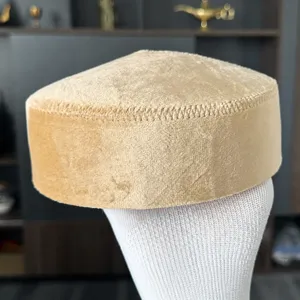 Close-up of khaki velvet Kazakh ethnic hat, showing soft fabric and fine stitching details.