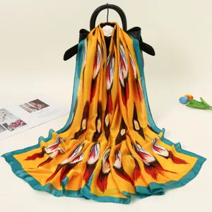 Detailed view of the vibrant yellow ethnic style silk scarf with blue border display scene.