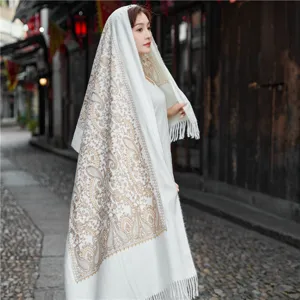 Exquisite embroidered paisley shawl detail showcasing elegant ethnic style and warm cashmere feel.
