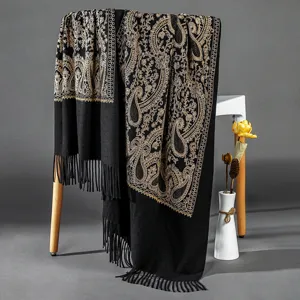 Elegant black cashmere-feel winter shawl with exquisite gold paisley embroidery and stylish tassels.
