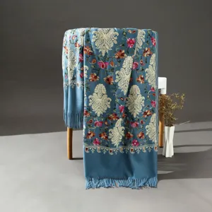 Exquisite ethnic embroidered cashmere-feel scarf detail, featuring intricate floral patterns and tassels.