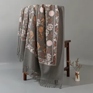 Close-up detail showing the exquisite floral embroidery and fringe on the shawl.