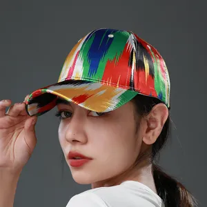 Detailed view of the ethnic style satin baseball cap with vibrant multi-color traditional print.