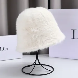 Detailed view of fluffy white rabbit hair bucket hat on display stand. Soft winter fuzzy cap.