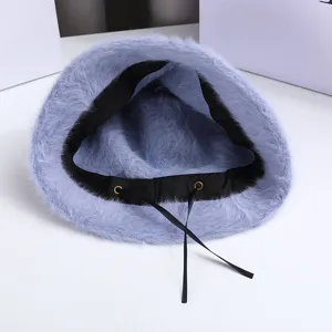 Fuzzy blue bucket hat inner detail, soft winter furry hat with black strap and metal eyelets.