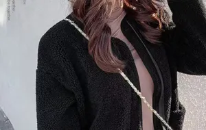 Gros plan sur la texture d'une veste en polaire noire et sa fermeture éclair, style automne.