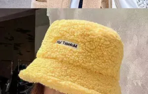 Détail gros plan du bob en fausse fourrure jaune avec logo brodé pour hiver chaud.