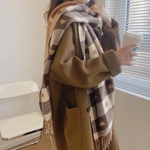 Detailed view of women autumn winter cozy thick heart plaid cashmere feel scarf with tassel.