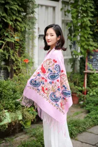 Detailed view of the pink ethnic paisley embroidered wool blend shawl scarf with fringe.