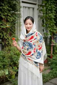 Close-up of the elegant embroidered cashmere-feel scarf with intricate paisley designs.