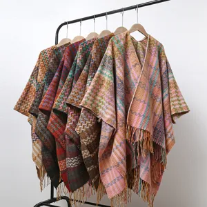 Colorful boho chevron knit poncho detail, cozy fringed hem and soft draped ethnic cape style.