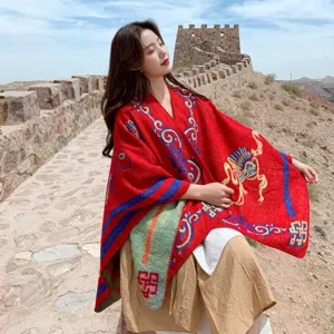 Ethnic style red woolen shawl cloak with vibrant colorful patterns for women outdoor travel.