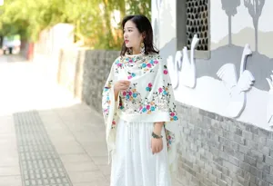 Detail view of the elegant embroidered cashmere shawl, featuring vibrant ethnic floral patterns.