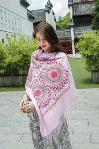 Close-up detail view of women ethnic style colorful embroidered cashmere feel winter warm fringe scarf.