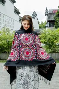 Detailed view of the ethnic winter sunflower embroidered cashmere-like shawl scarf with fringe.