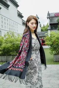 Ethnic style embroidered shawl, detailed sunflower pattern, tassel trim, winter cozy accessory.
