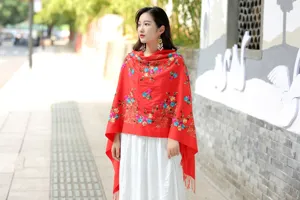 Detailed view of women red embroidered cashmere shawl, ethnic floral style winter warm wrap.
