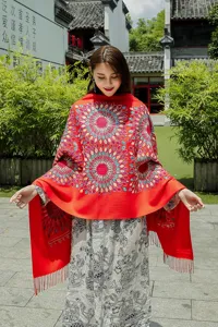Detailed view of ethnic style embroidered cashmere-feel shawl with vibrant sunflower pattern and tassels.