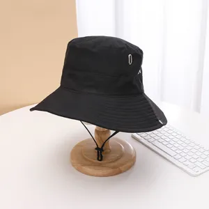 Black quick-dry bucket hat for outdoor hiking, camping, and climbing with windproof drawstring.