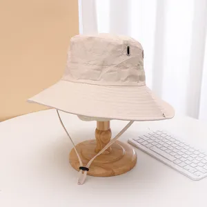 Quick-dry bucket hat detail view, wide brim, adjustable chin cord, breathable eyelets for hiking.