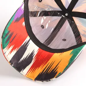 Detail close-up of vibrant Xinjiang ethnic style colorful printed baseball cap brim and interior.