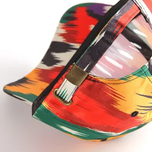 Close-up detail of a colorful ethnic style printed baseball cap with adjustable metal buckle.