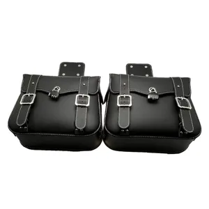 Black leather motorcycle saddlebags pair with white stitching and silver buckles for bike storage.
