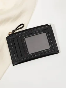 Black minimalist card holder with zipper pocket and clear ID window, detailed closeup.