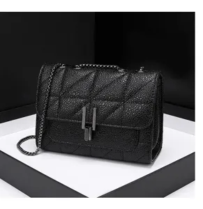Black quilted chain shoulder bag detail showing unique metal clasp and textured leather.