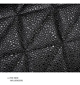 Detailed view of the black quilted texture leather bag surface, showcasing premium craftsmanship.