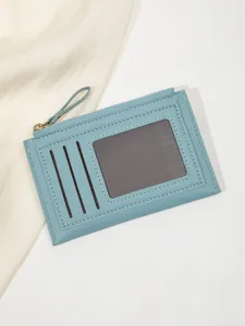 Detail view of a slim blue card holder wallet featuring multiple slots and zipper coin pocket.
