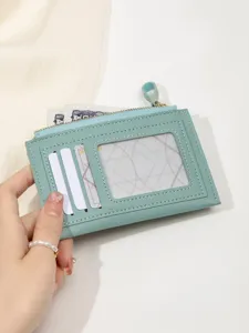 Mint green slim cardholder detail showing multi card slots, ID window and zipper coin pocket.