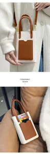 Minimalist color-block mini handbag with lychee grain leather, top handle and adjustable strap.