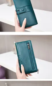 Close-up detail view of the dark green women's long wallet featuring a dual zipper design.